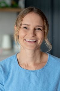 Dannielle Pickford smiling in a blue shirt looking at the camera