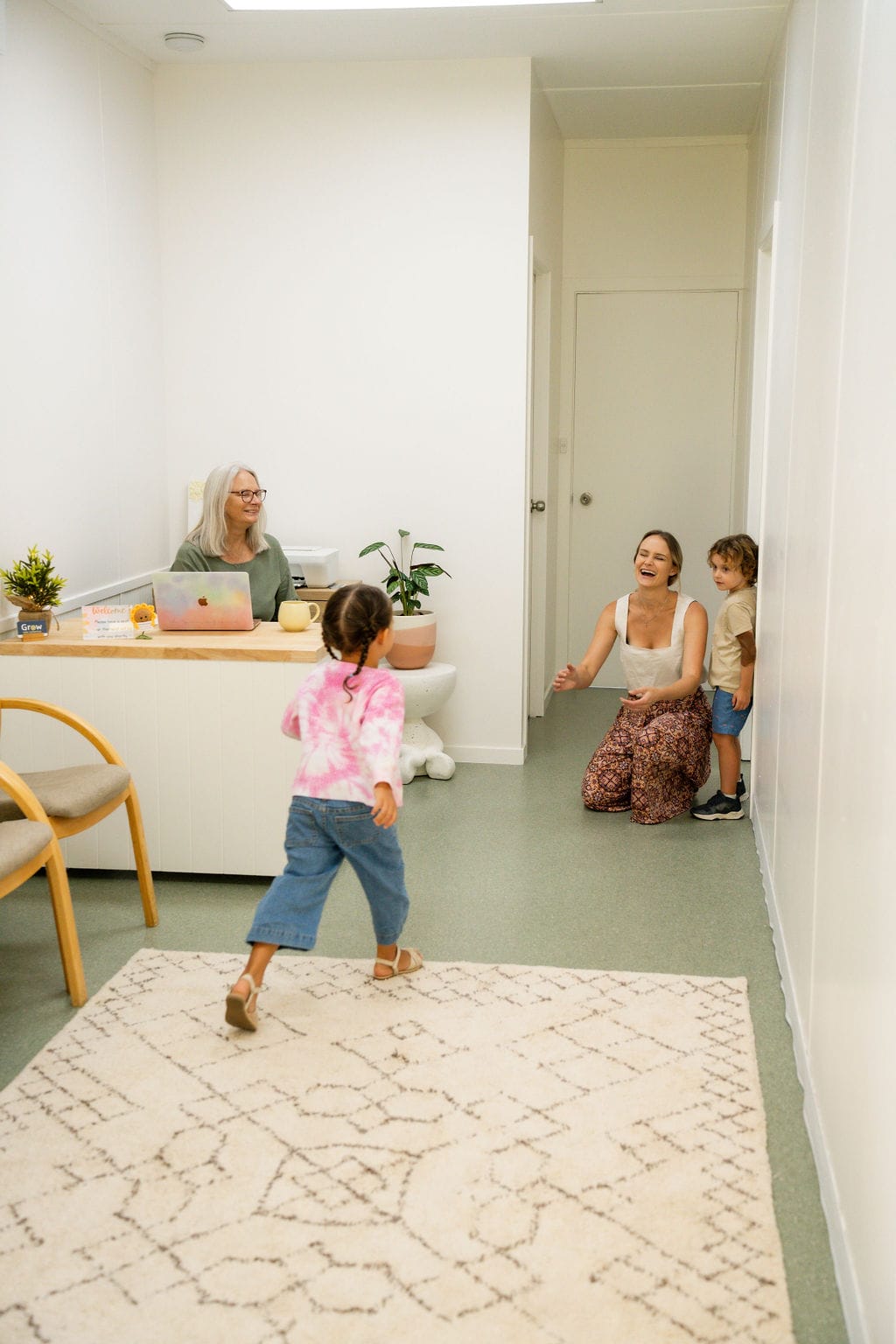A child running to hug her Paediatric physiotherapist at the centre reception