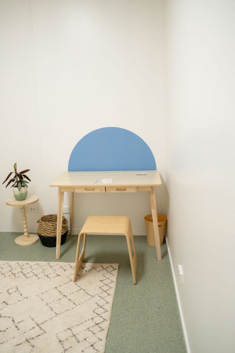 A small room with a desk and a chair.