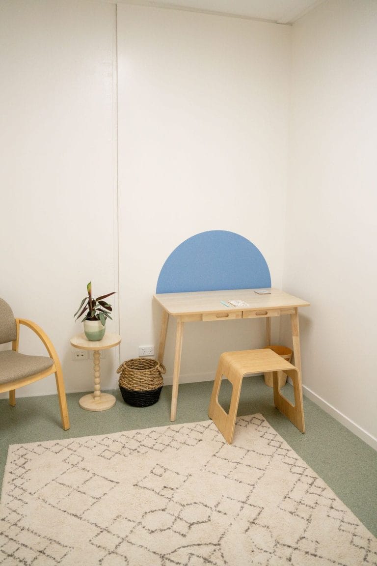 A small room with a desk and chair.