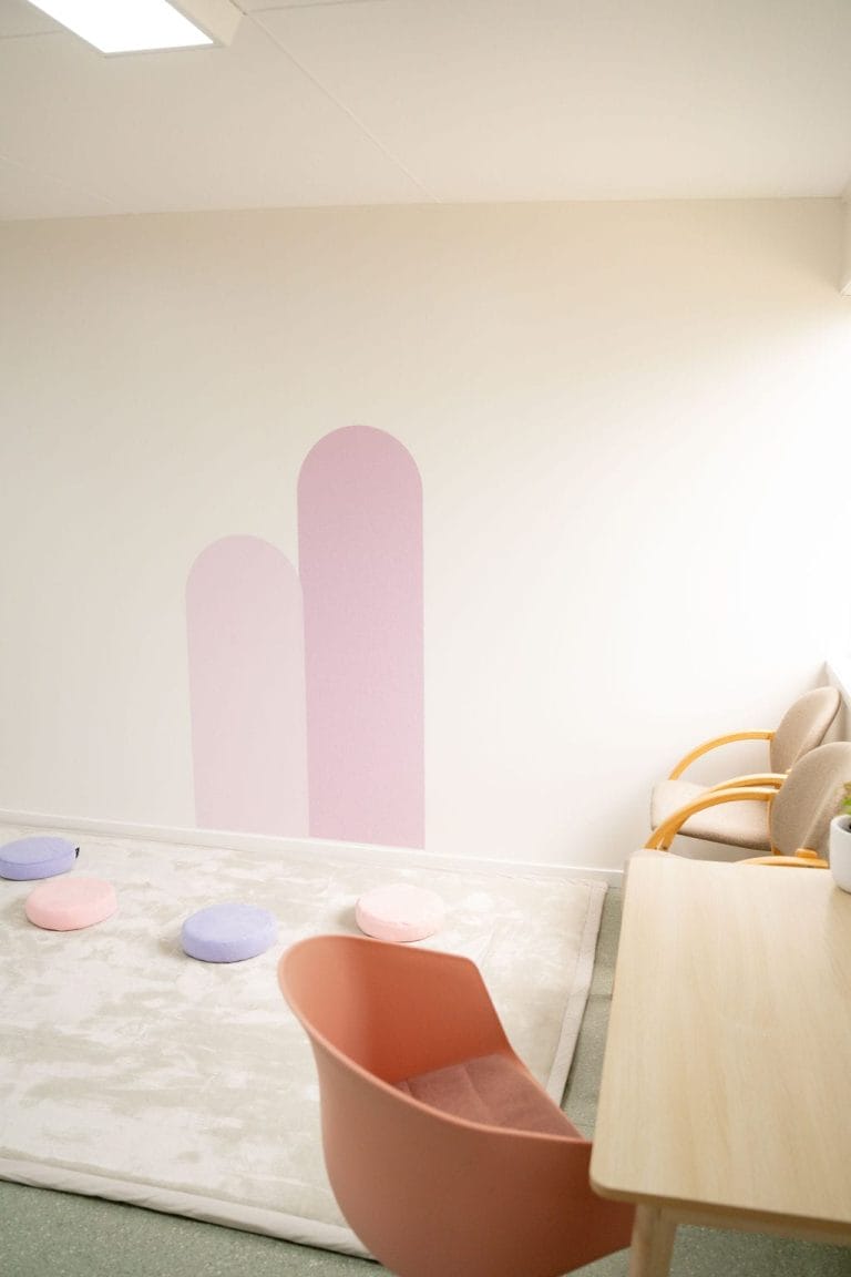 A room with a table and chairs.